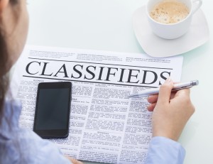 Businesswoman Reading Classifieds